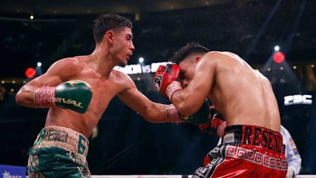 Elijah Garcia (L) trades punches with Armando Resendiz of Mexico during their middleweight fight. Elijah Garcia media workout in Phoenix. SARAH STIER. 